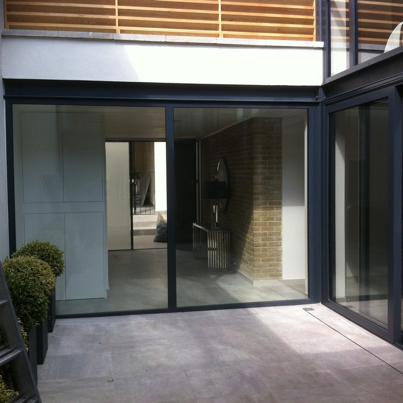 Floor-to-ceiling sliding doors opening to courtyard in Harpenden