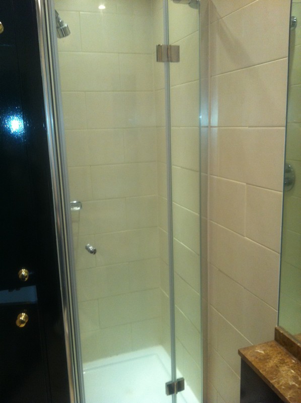 Frameless glass shower enclosure with chrome fittings in Harpenden