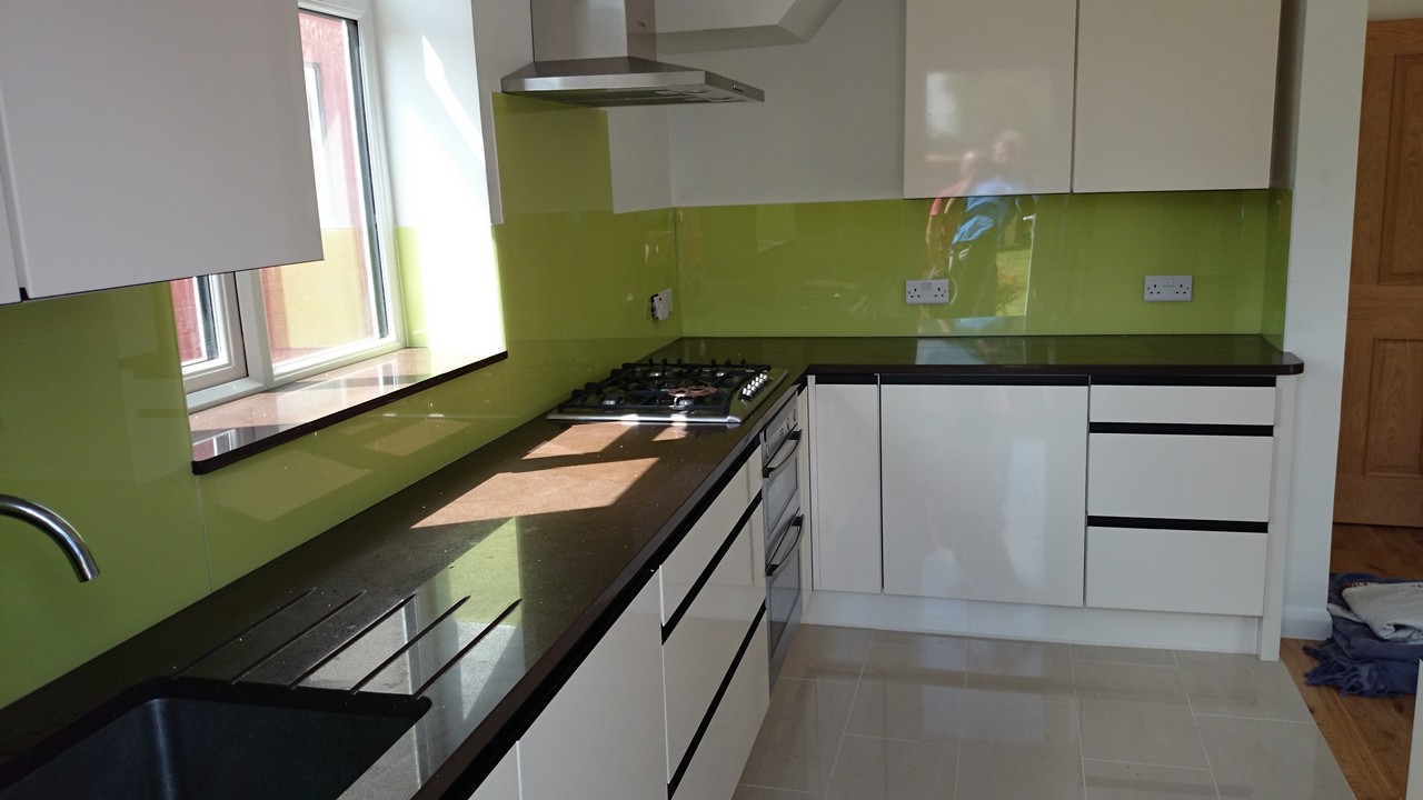 Lime green glass kitchen splashback installed by Harpenden glaziers
